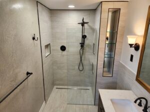 A beautifully completed modern bathroom renovation featuring a walk-in shower and new vanity by Ace Tile & Finishing LLC in Philadelphia, PA.