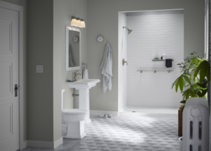 A modern bathroom renovation featuring a pedestal sink, toilet, and walk-in shower by Pacific Bath in Portland, OR.