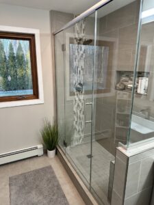 Modern bathroom shower remodel with glass enclosure and tile work by Top Notch Contracting in Racine, WI.
