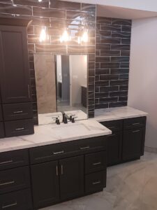 Modern bathroom vanity installation with dark cabinets and subway tile backsplash by APS Residential Services in Livonia, MI.
