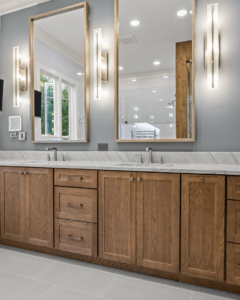 A modern bathroom vanity with dual sinks, marble countertop, and wooden cabinets installed by Blue Ribbon Residential Construction, Inc. in Raleigh, NC.