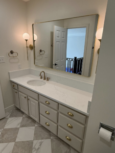 A modern bathroom vanity with a new countertop, sink, faucet, mirror, and lighting installed by Patriot Tile LLC in Skiatook, OK.