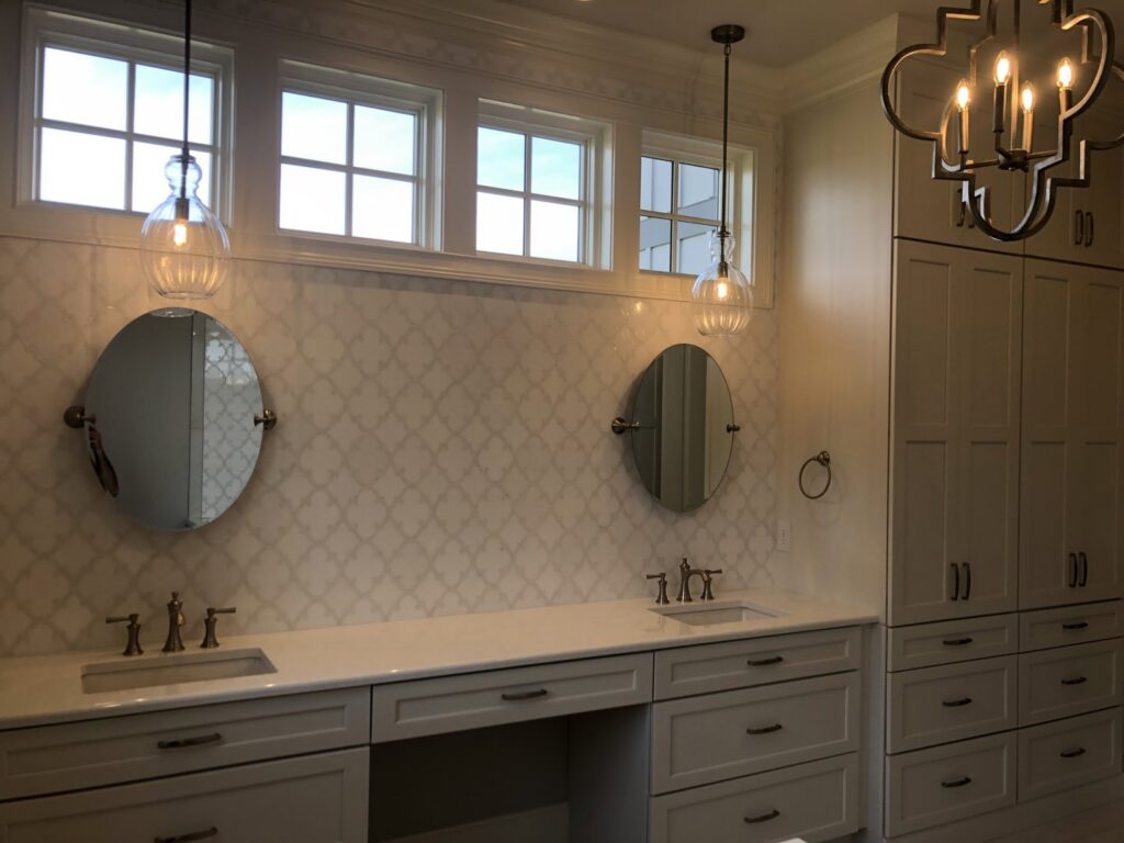 A newly installed modern bathroom vanity with dual sinks, mirrors, and pendant lighting by Specialty Service Group in Knoxville, TN.