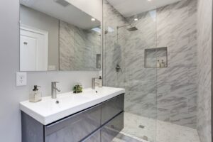 Modern bathroom with double vanity and walk-in shower installed by Cabido Design in Brentwood, MD.