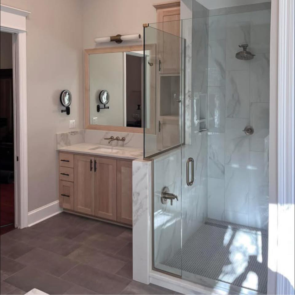 A modern bathroom featuring a new vanity and walk-in shower by Ourso Renovations in Baton Rouge, LA