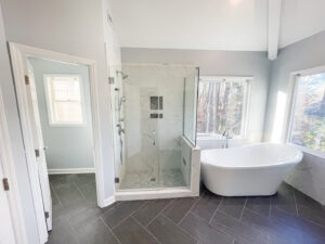 A modern bathroom featuring a large walk-in shower and freestanding tub by Berco Construction LLC in Godfrey, IL