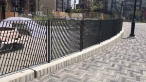 Stylish modern black metal fence with a unique diagonal pattern installed by National Fence Systems, Inc. in Avenel, NJ.