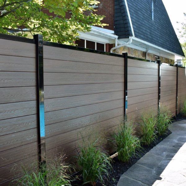 Modern brown horizontal slat fence with black posts installed by Xclusive Fence And Rails Inc. in Miami, FL.