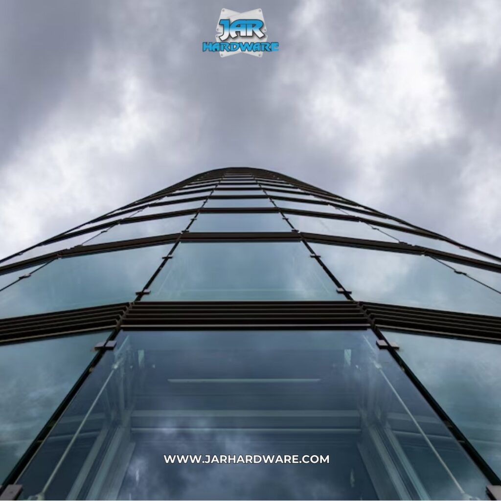 Upward view of a modern building with an impressive curved glass facade installed by Jar Hardware in Hialeah, FL.