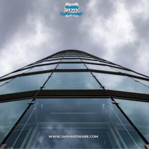 Upward view of a modern building with an impressive curved glass facade installed by Jar Hardware in Hialeah, FL.