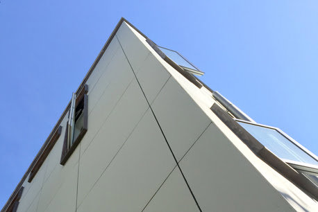 A striking modern building exterior with unique architectural lines and windows, built by Kaleidoscope Design Build in Houston, TX.