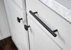 Modern black handles and knobs installed on white kitchen cabinets by Preferred Millworks & Design in Edmond, OK.