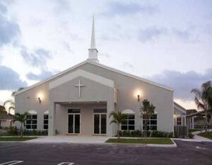 Modern church building exterior with steeple and cross, a completed project by Walker Design & Construction Co. in Boca Raton, FL.