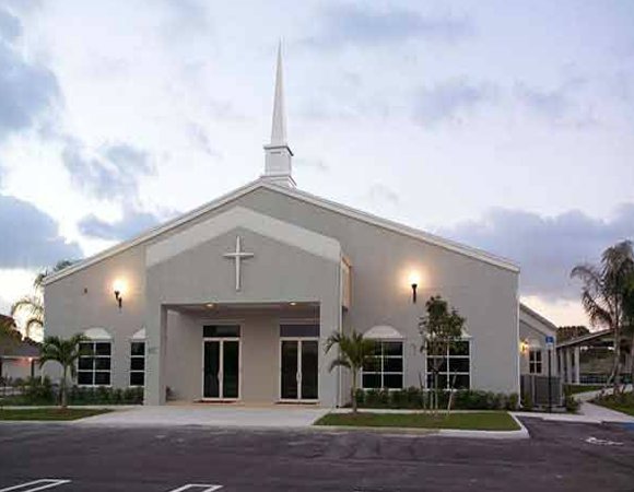 Modern church building exterior with steeple and cross, a completed project by Walker Design & Construction Co. in Boca Raton, FL.