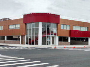 A modern commercial building exterior with red and brown panels by GCM, INC. in Mount Joy, PA.