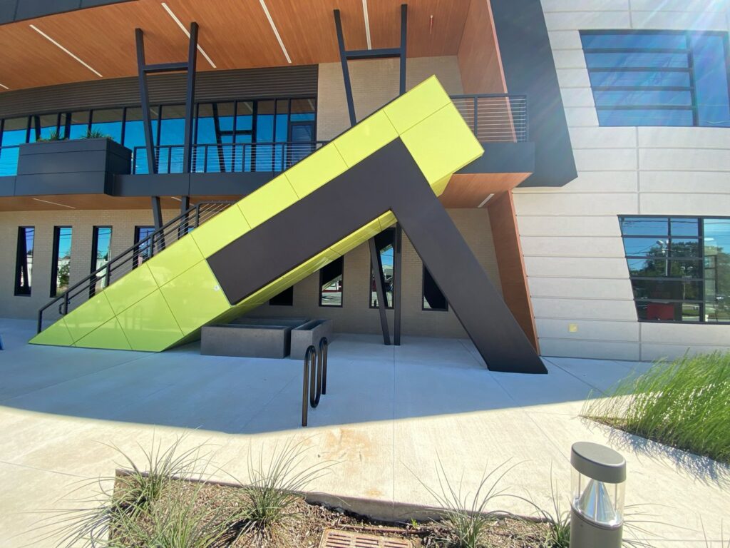 The modern exterior facade of a commercial building, showcasing a general contractor's renovation work by Spectrum Paint and Commercial Services, Inc. in Houston, TX.