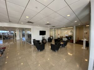 A modern commercial office waiting area with glass partitions, a completed interior renovation by Spectrum Paint and Commercial Services, Inc. in Houston, TX.