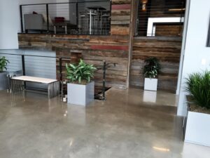 A modern commercial space with polished concrete floors and wooden wall accents by Heavy Duty Floors, LLC in New Britain, CT.