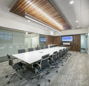 A modern conference room with a long table and chairs, completed by Reeder General Contractors, Inc. in Fort Worth, TX