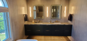 A modern double vanity with floating cabinets and sleek lighting from a bathroom remodel by JMS Construction in Las Vegas, NV