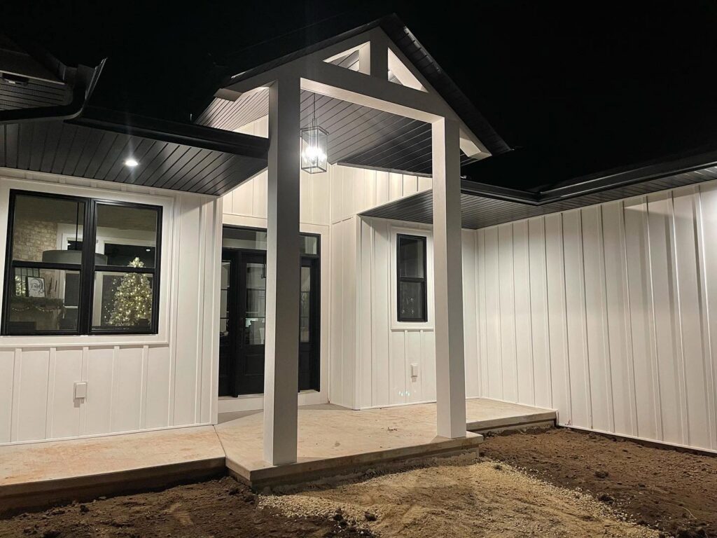 A modern exterior porch with new lighting and dark trim work by L12 Construction LLC in Oshkosh, WI.