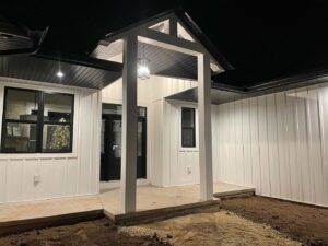 A modern exterior porch with new lighting and dark trim work by L12 Construction LLC in Oshkosh, WI.
