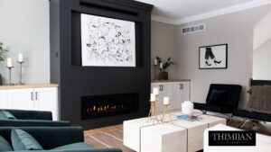 A contemporary living room with a gas fireplace and mounted abstract artwork, completed by Thimijan Custom Homes LLC in Rochester, MN