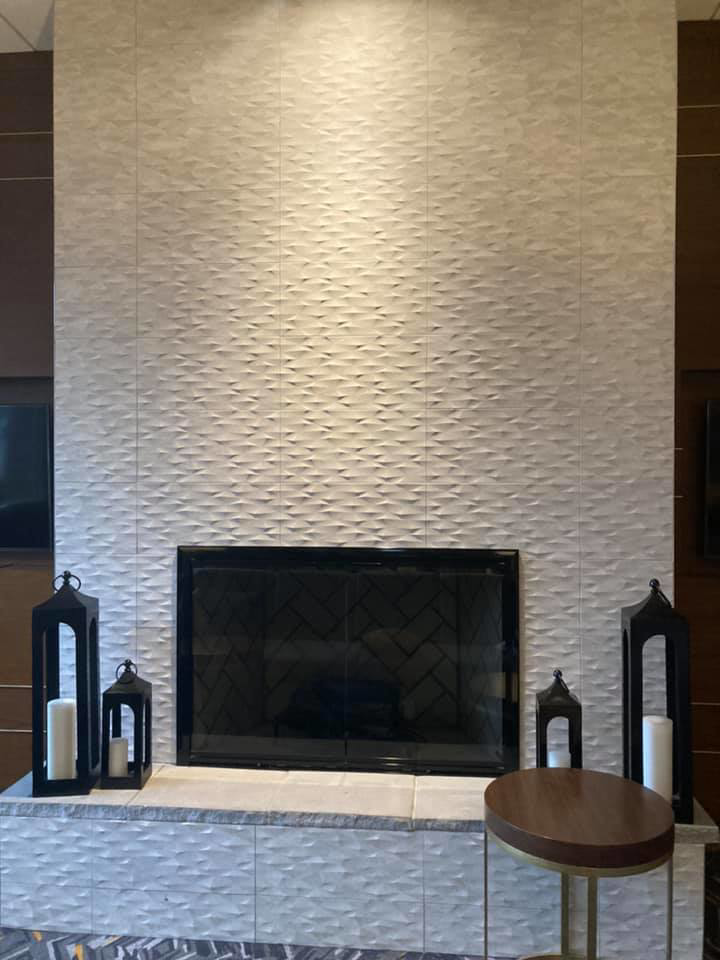 Modern fireplace with a full textured tile surround and hearth installed by Old Style European Stucco & Masonry in Brentwood, TN