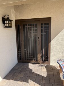 A modern security screen door with geometric patterns and side panels installed by Affordable Fence & Gates in Tucson, AZ.
