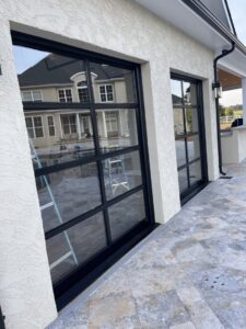 Exterior view of modern glass garage doors installed by Total Garage Works in Indian Trail, NC.