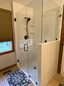 Modern glass shower enclosure with black fixtures installed by Thermal Concepts, Inc in St. Louis, MO.