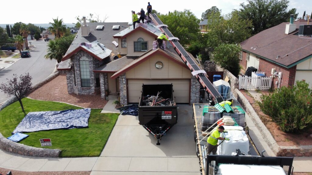 A modern home under construction with exterior walls painted white and green accents, nearing completion by Masota Construction in El Paso, TX.