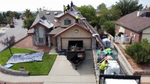 A modern home under construction with exterior walls painted white and green accents, nearing completion by Masota Construction in El Paso, TX.