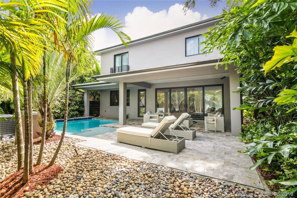 A modern home exterior with a pool, showcasing completed remodeling work by FHIA Remodeling in Fort Lauderdale, FL