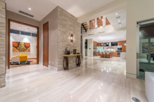 Modern home interior with an open-concept kitchen and living area, a completed project by Plumb Partners LLC in Miami, FL.