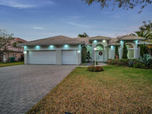 A modern house exterior with a paved driveway, completed by Property Solutions Network, Llc in Hialeah, FL