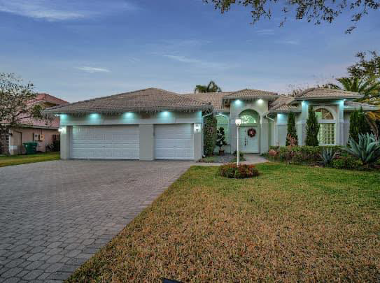 A modern house exterior with a paved driveway, completed by Property Solutions Network, Llc in Hialeah, FL