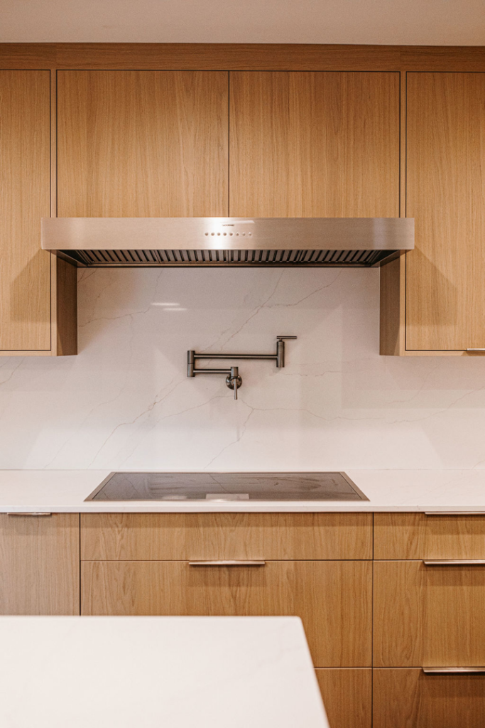 Modern kitchen featuring a newly installed tile backsplash and white quartz countertops by Atlantic Tile & Granite in Kent, WA.