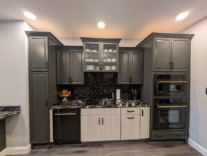 A modern kitchen and bar area renovation with dark cabinets and hexagonal backsplash by Shafer Construction, LLC in Bethlehem, PA.