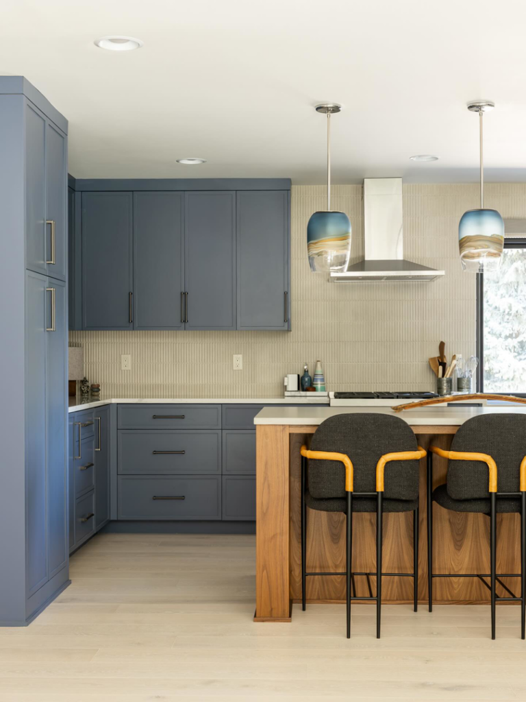 A modern kitchen featuring blue cabinets and a stylish island installed by JDI Construction in Vancouver, WA.