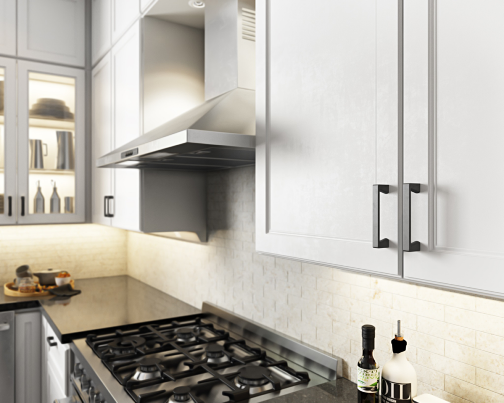 Modern kitchen with newly installed white cabinets, range hood, and gas stove by Preferred Millworks & Design in Edmond, OK.