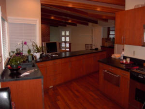 Modern kitchen cabinetry and exposed wooden beams installed by Hessel Carpentry in Portland, OR.