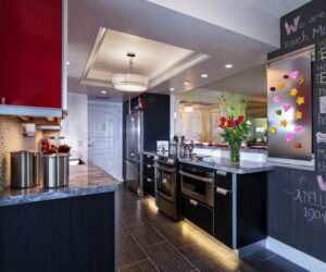 A contemporary kitchen remodel with dark cabinets, light countertops, and a unique chalkboard wall by Boisen Remodeling LLC in Appleton, WI.