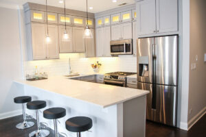 A modern kitchen design with white cabinets and an island, completed by 3F Construction in Chicago, IL.