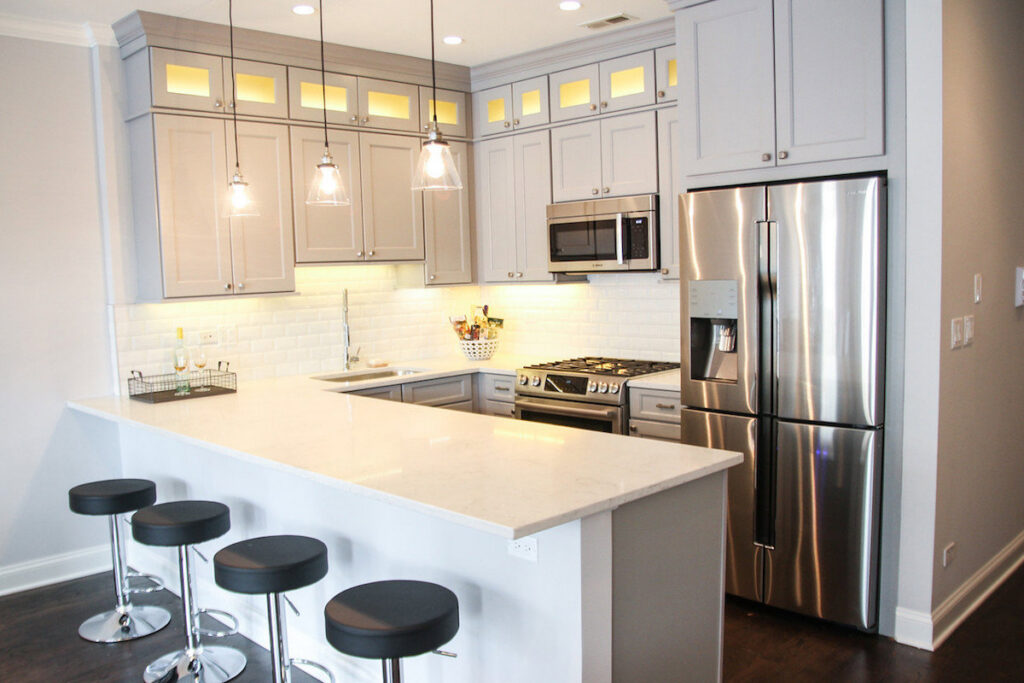 A modern kitchen design with white cabinets and an island, completed by 3F Construction in Chicago, IL.