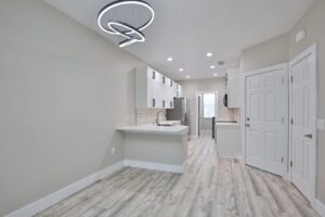 A modern kitchen and dining area after a complete renovation by ALKA Construction/ Handyman Services in Layton, UT