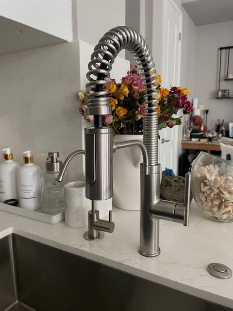 A modern kitchen faucet with a pull-down sprayer and soap dispenser installed by Henderson Handyman in Henderson, NV