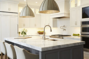 A modern kitchen with a large island and pendant lights, completed by Creasey Construction of Illinois, Inc. in Springfield, IL