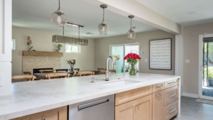 A bright, modern kitchen with a large island and stylish pendant lights by Homework Remodels in Phoenix, AZ.