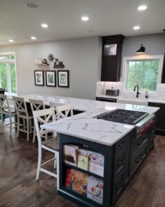 A spacious modern kitchen remodel with a large island, new cabinetry, and white quartz countertops by Boisen Remodeling LLC in Appleton, WI.